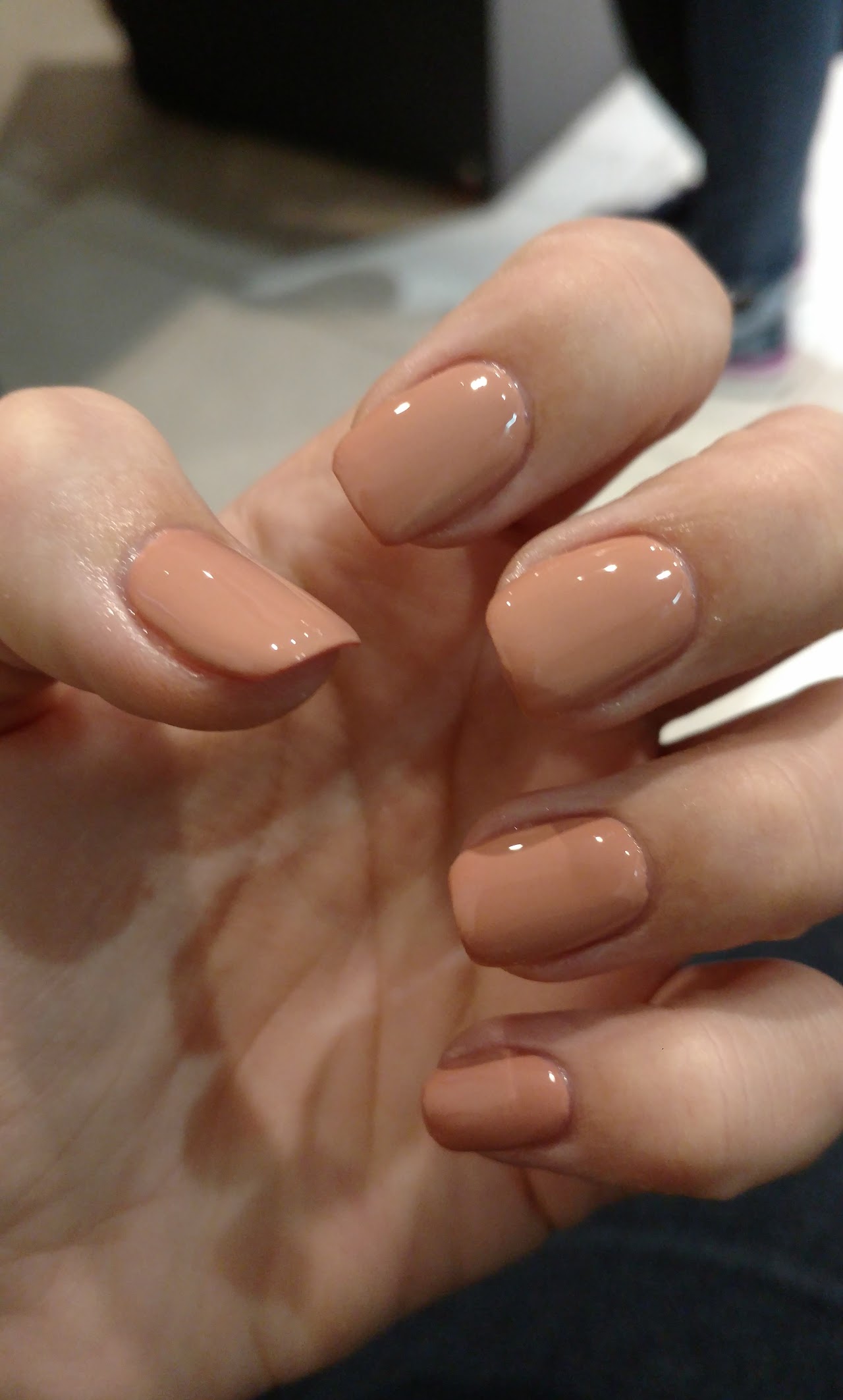 Close-up of meticulous clean gel manicure and nail art on elegant manicured hands, soft blush pink and nude glossy finish, luxury beauty salon setting, soft bokeh, aesthetic treatment studio, high resolution spa photography